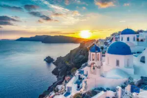 Corporate team hosting a retreat on a terrace overlooking the Aegean Sea in Greece, one of the best event destinations for 2025.